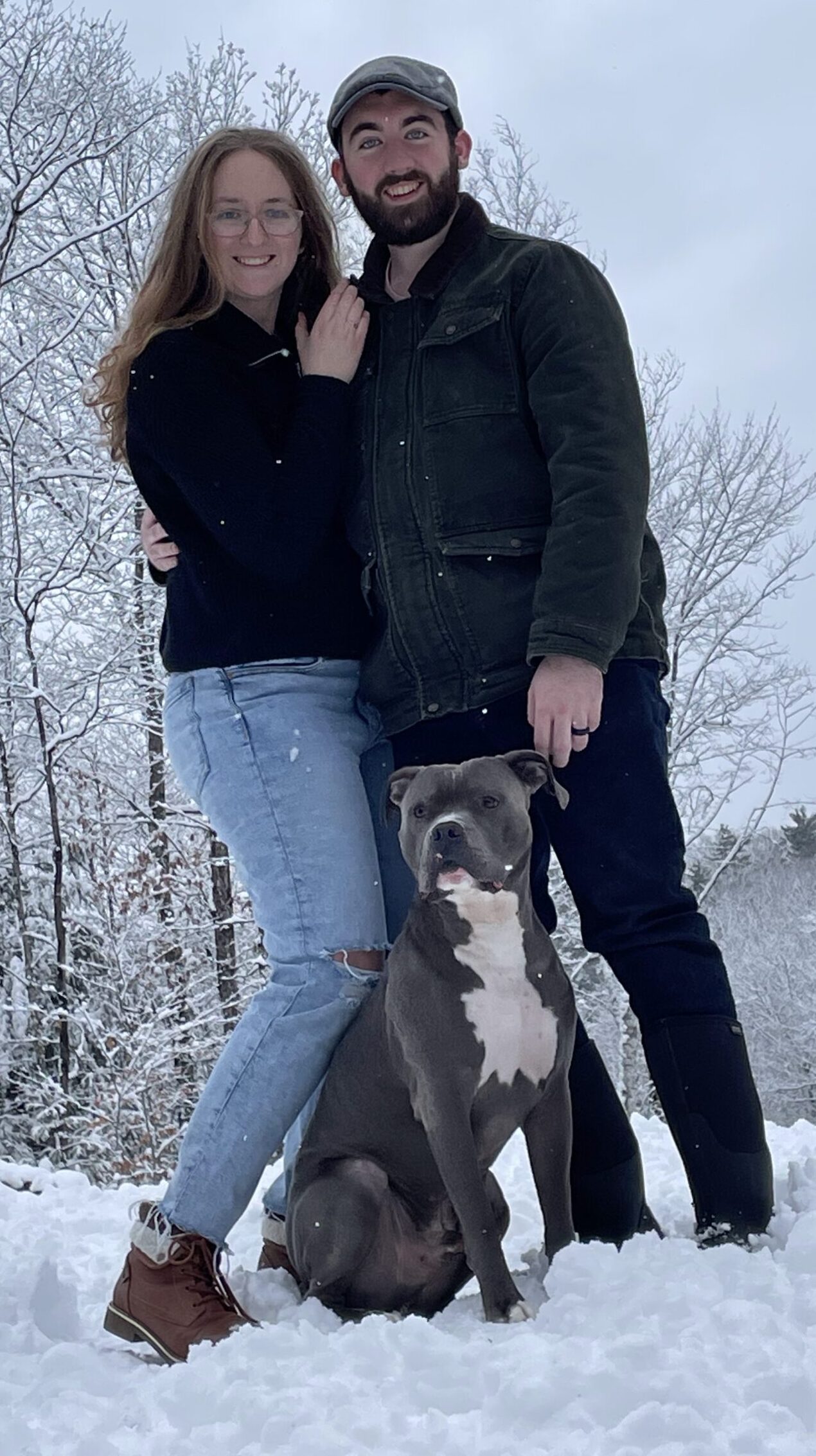 Alex and Kelly standing with their dog during a New Hampshire dog training session